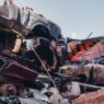 A wrecked vehicle in a salvage yard, illustrating how insurers calculate a total loss settlement