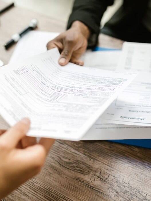 Open enrollment benefits paperwork and a calculator on a desk