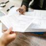Open enrollment benefits paperwork and a calculator on a desk