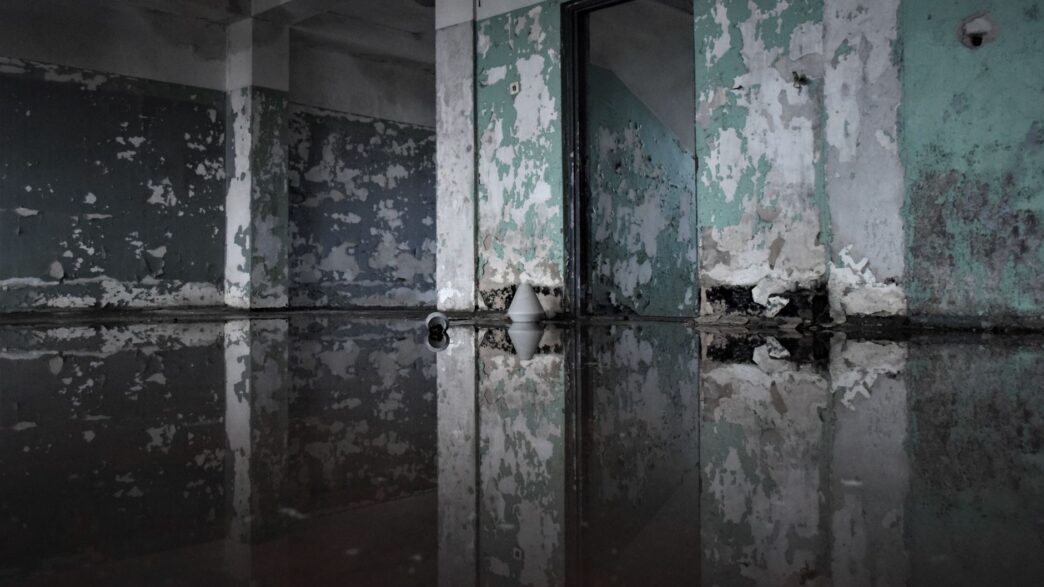 Standing water in a residential basement, illustrating why water backup coverage limits matter