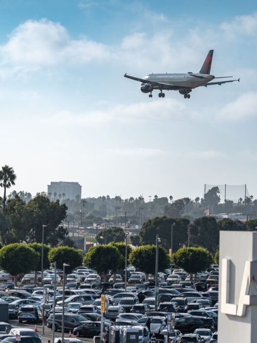 Rows of parked cars in an airport economy parking lot before holiday travel
