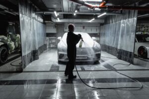 Car going through an automatic car wash tunnel covered in foam