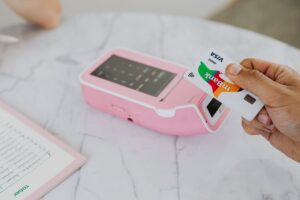 Shopper paying with a debit card at a store checkout terminal