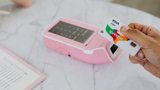 Shopper paying with a debit card at a store checkout terminal