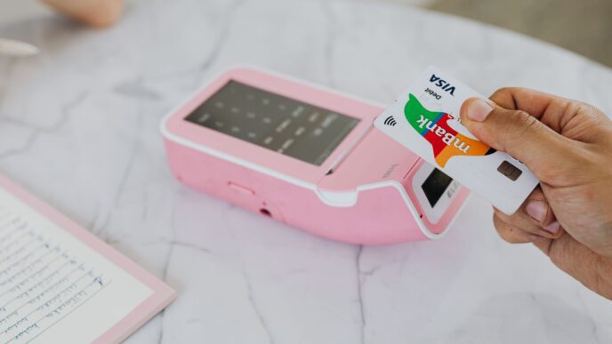 Shopper paying with a debit card at a store checkout terminal