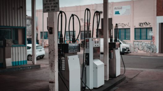 Driver refueling a car at a gas station pump, illustrating record September 2026 gas prices and fuel budgeting