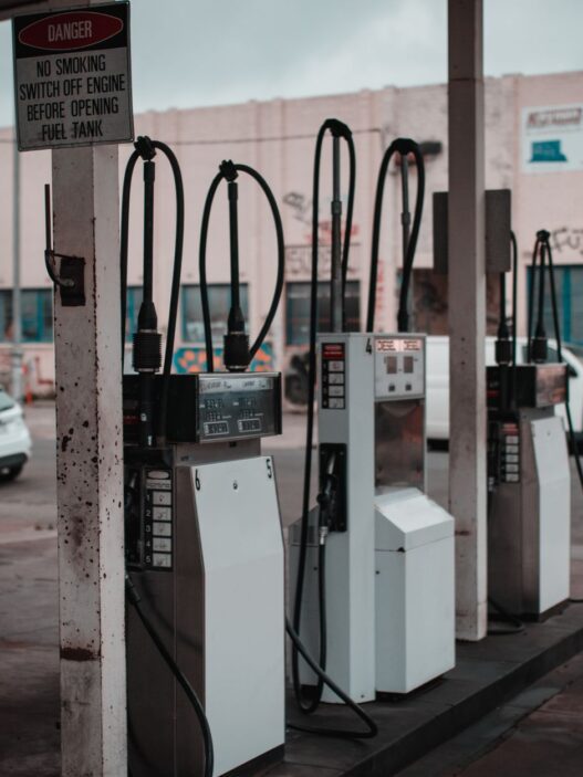 Driver refueling a car at a gas station pump, illustrating record September 2026 gas prices and fuel budgeting