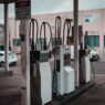 Driver refueling a car at a gas station pump, illustrating record September 2026 gas prices and fuel budgeting