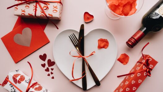 Diners sharing a restaurant meal, illustrating how to use holiday gift card bonus deals before they expire