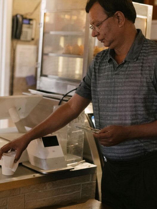 Person paying with cash at a store counter