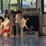 Travelers waiting in line at an airport security checkpoint during busy holiday travel