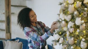 Decorated artificial Christmas tree in a living room, illustrating real vs artificial Christmas tree cost