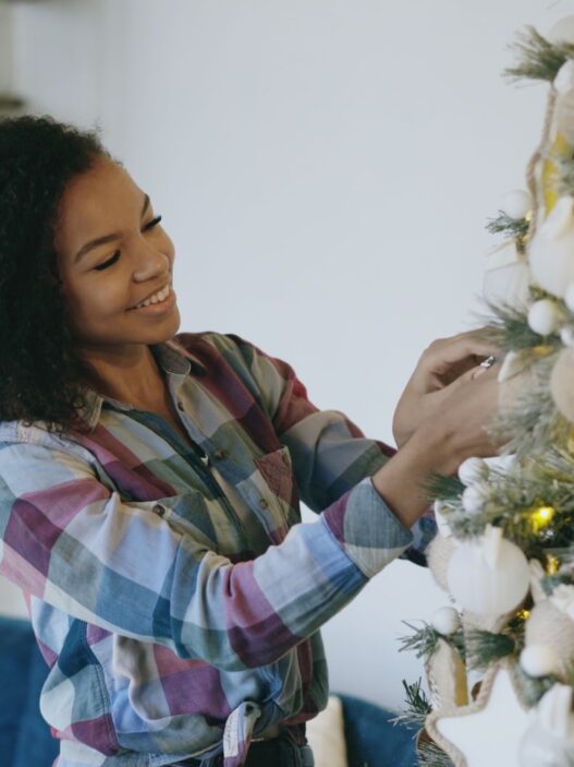 Decorated artificial Christmas tree in a living room, illustrating real vs artificial Christmas tree cost