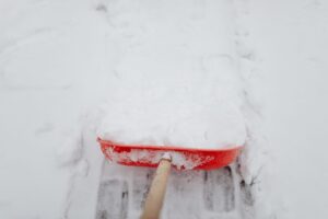 Snow-covered residential driveway after a winter storm, illustrating snow removal cost decisions